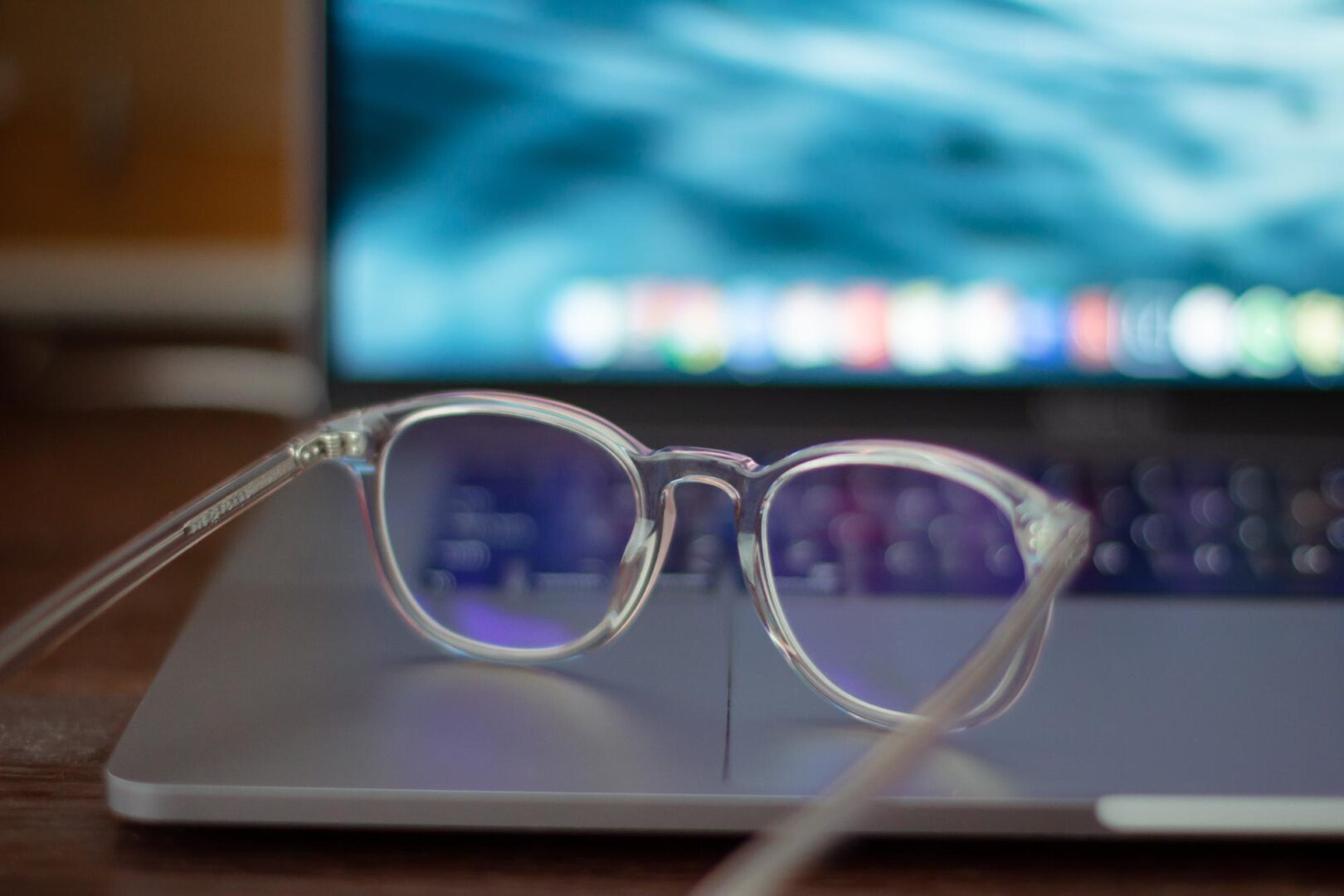 Transparent eyeglasses lying on a laptop. by K8
